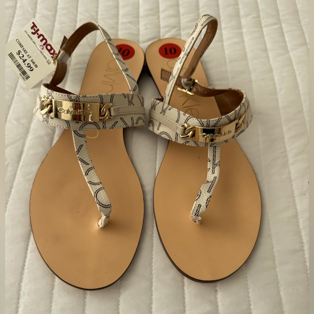 NWT Calvin Klein sandals. White with black CK pattern and gold hardware.